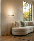 Leaf Pharmacy LED Reading Lamp With Dimmable Floor Lamp Design Adjustable Rotation Over Chair Or Desk Perfect For Living Rooms And Offices Sewing And Crafts Antique Brass Finish next to a modern sofa.