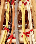 Lothee 200 Pack Red Cable Staples Clips With Steel Nails used to secure multiple data cables on wooden framing.