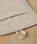 Close-up view of a Ribbed Soft Silicone Pot Holder 2 Pack Set Hella Heat Resistant To 500F Milkshake Tan with hanging loop.
