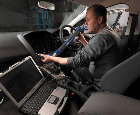 Technician using a rugged Panasonic laptop in a vehicle, operating equipment with Tank Like Mobile Workstation With 13.1 Inch Xga Touchscreen Intel Core I5 2.3Ghz Chipset 16Gb Ram 1Tb Ssd 4G Lte Link Backlit Keyboard Windows 10 Pro Rock Solid For Rough Daily Hustle And Heavy Duty Jobs.