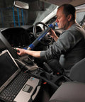 Technician using Built Like A Tank CF-31 Rugged Business Laptop for vehicle diagnostics in car interior.