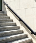 Hella Tough Adjustable Stair Handrail With Custom Cut Industrial Steel Finish Weatherproof Indoor Outdoor Grab Bar alongside grey stone steps.