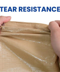 Hands displaying tear resistance of Beige 6x8 Heavy Duty Waterproof Tarp 12.5 Mil Ultra Tough Tear Resistant Poly Cover for outdoor use.