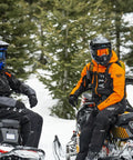 Two riders wearing Carbon Snowmobile Suit Set With Hydraguard Pro Tech Ride Ready 10K Waterproof And 8K Breathable Shell Jacket And Bibs