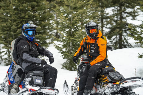 Two riders wearing Carbon Snowmobile Suit Set With Hydraguard Pro Tech Ride Ready 10K Waterproof And 8K Breathable Shell Jacket And Bibs