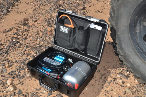 Heavy Duty Road Trip Ready 12 Volt Twin Motor Portable Air Compressor in protective case with tank and accessories.