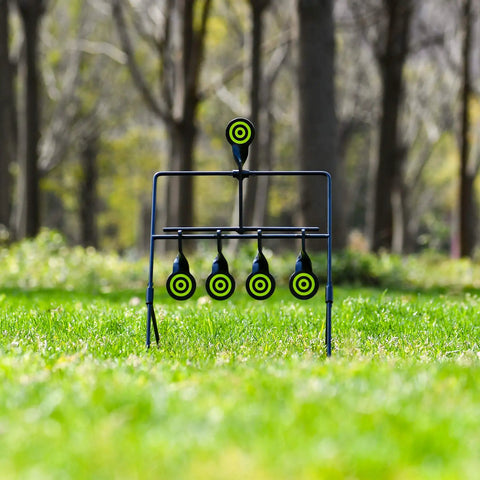 Resetting Steel Target Set For Airsoft BB Guns And Rimfire Caliber 22 And 177 in a grassy outdoor setting
