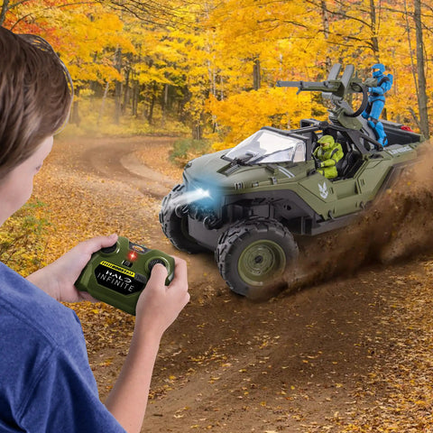Child using controller to operate Halo Infinite RC Battle Hog UNSC Warthog with Master Chief and Spartan in autumn forest