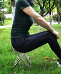 Person sitting on Portable Oxford Cloth Folding Stool Camping Chair With Sturdy Aluminum Frame Lightweight And Durable Breathable Seat