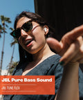 Person wearing Tune Flex True Wireless Earbuds With Pure Bass Sound From 12mm Drivers, enjoying music outdoors