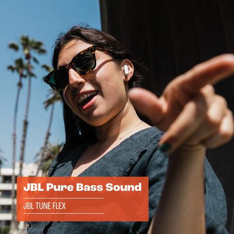 Person wearing Tune Flex True Wireless Earbuds With Pure Bass Sound From 12mm Drivers, enjoying music outdoors