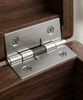 Close-up of 2 inch stainless steel spring hinge on wooden door frame, part of Set Of Four 2 Inch Stainless Steel Spring Hinges Self Closing.