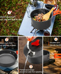 17 Piece Campout Friendly Camping Cookware Kit With Large Pot And Small Kettle Plus 7 Inch Frying Pan Includes 2 Cups 2 Plates 2 Sets Of Utensils For Hiking Backpacking Outdoor Cooking And Picnics featuring anodized aluminum cookware with orange handles on a camping table.