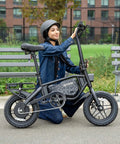 Person sitting near Foldable Electric Bike With Carry Handles Portable 350W Pedal Assist Twist Throttle Up To 15.5 MPH 14 Inch Tires