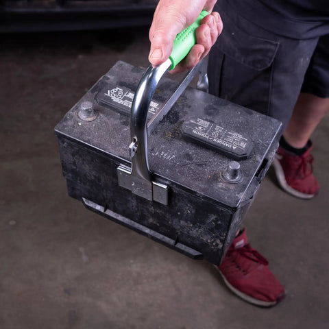 Heavy Duty Battery Carrier Lifter And Grab Tool For Top Post And Side Post Batteries With Rubber Pad Grip in use lifting a battery