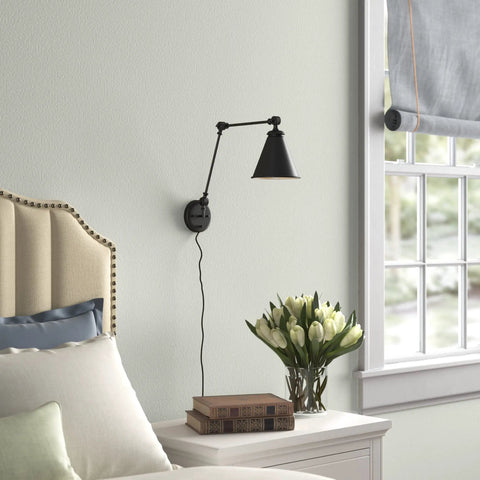 Vintage Adjustable Swing Arm Wall Lamp Black Dope Industrial Style Wall Sconce With Plug In Or Hardwired On Off Switch Ideal For Desk Or Bedside Reading Light in bedroom setting with bed and flowers.