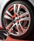 Close-up of a car wheel with a Bullet Shell Tire Valve Stem Caps Set In Aluminum Alloy, showcasing the sleek black cap on an air valve.