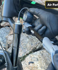 ShockPro MTB Shock Pump With 300 PSI High Pressure Gauge in use on mountain bike fork