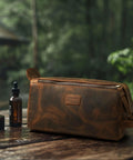 Top Shelf Genuine Buffalo Leather Toiletry Bag For Men And Women Brown Travel Organizer With Waterproof Inner Compartment on wooden table outdoors.