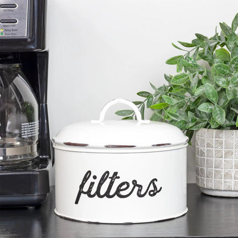 Basket Style White Enamel Coffee Filter Holder, The Go To Rustic Farmhouse Distressed Look, Shabby Chic Kitchen Organizer, next to a plant.