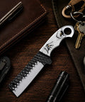 Cowboy Style Fixed Blade Knife with resin handle for camping, ranch work, and hunting, shown with everyday carry items on table