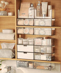 Two Tier Drawer Organizer For Medicine Cabinet Stackable Clear Storage Drawers with toiletries and cosmetics on shelf.