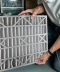 Person holding Air Bear 20 x 25 x 5 Inch MERV 8 High Performance Air Purifier Filter Replacement, showing front panel detail