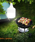 Go To All Night Camping Lantern Dimmable 8800mAh LED Light hanging above a grill with skewers near a tent at night
