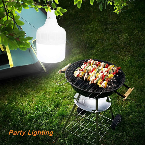 Go To All Night Camping Lantern Dimmable 8800mAh LED Light hanging above a grill with skewers near a tent at night
