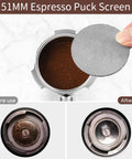 Front view of a 51mm stainless steel bottomless portafilter with puck screen and coffee grounds