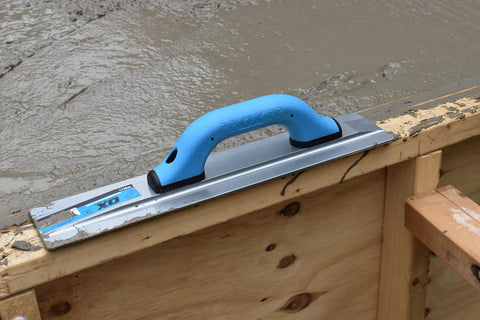 Pro-Grade Magnesium Concrete Float 3-1/8 x 16 In with beveled ends and rounded corners, on wooden slab edge