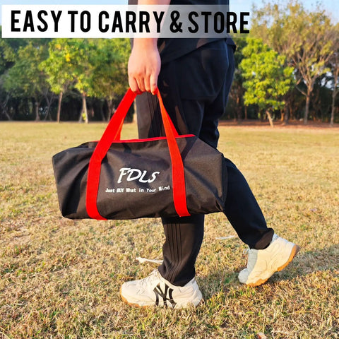 Person carrying a black and red sports bag on a grassy field