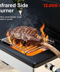 Close-up of a Six Burner Propane Gas Grill With Infrared Sear Side Burner, grilling steak with flames on diamond pattern grate.