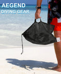 Person holding mesh carry bag on beach for 2 Pack Dry Snorkel Set For Adults With Panoramic View Dope Anti Leak And Anti Fog Tech
