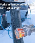 Orange 16 Gauge 3 Prong Grounded Extension Cord 100 Ft Heavy Duty Outdoor Power Cable with lit connector in snow