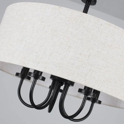 Close-up of black metal semi flush mount ceiling light with white drum shade