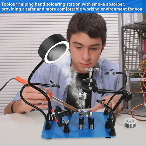 Young man using Magnetic Helping Hands Soldering Third Hand Tools With Pro Grade Lighted Solder Fume Extractor for electronics repair.