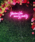 Massive 28 Inch Pink Neon Sign You're Like Really Pretty LED Light for Bedroom Bar Club Wall Decor against floral backdrop