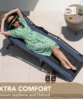 Woman relaxing on 4 Fold Padded Portable Outdoor Chaise Lounge Chair With Pillow And Side Pocket in blue on patio