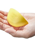 Hand holding a yellow memory foam shoe insert for big shoes fit unisex toe box fillers for wide feet or differing sizing.