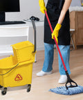 Person using Beefy Heavy Duty Mop Head Replacement For General And Floor Cleaning, Wet Industrial Blue Cotton Looped End String Refills in office