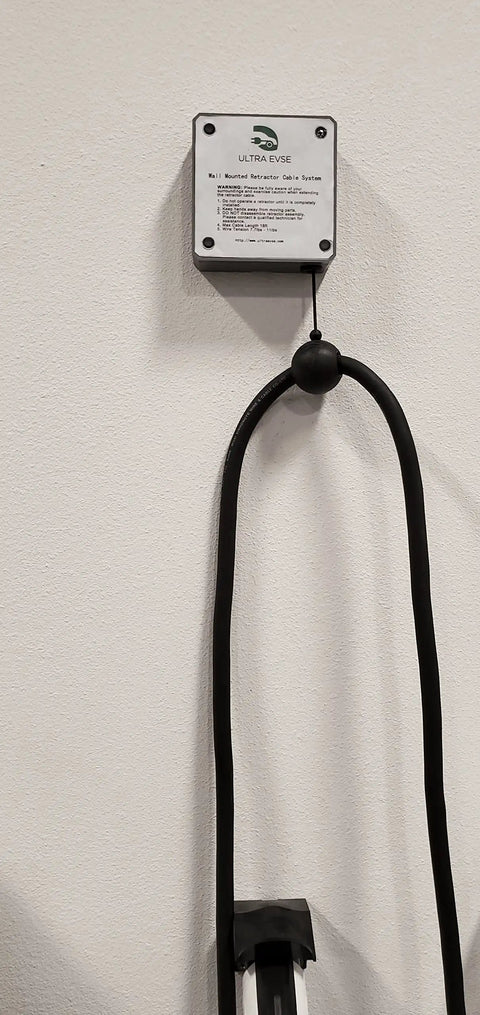 Top Shelf EV Charger Cord Retractor Keeps Your Charge Wire Locked Down And Beat Up Proof No Fuss Garage Setup Heavy Duty Wall Mount Bracket For J1772 Plugs Smooth Glide Action with black retractable cable holder mounted on wall.