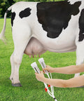 Person using 3L Electric Pulsation Milking Machine For Cows And Goats, Portable Vacuum Milker on cow in field.
