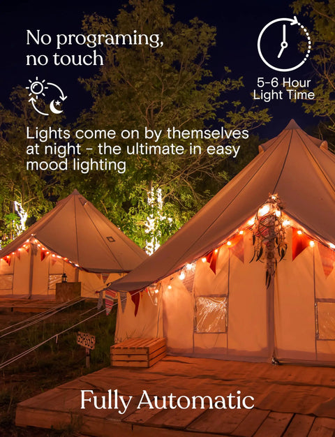 Canvas tents with Ambience Pro Solar Powered Outdoor String Lights With Remote Control And Edison Bulbs illuminating at night.