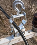 Rugged Heavy Duty Cable Pulley Cast Aluminum Wheel Wear Resistant Sheave installed on electrical pole with safety lock hook