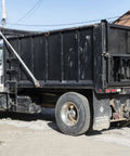 Beefy Steel Dump Truck Inspection Door With 12.38 x 13.5 Inch Opening, Detent Holder, Reversible Handle, Zinc Coated Paintable Finish For Medium And Heavy Duty Dump Trucks Built To Last, rear view on black dump body