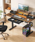 GIFZES Electric Standing Desk With 10 RGB LED Lighting Modes And Power Outlets For Gaming Or Office Setup, detailed view with monitor and accessories.