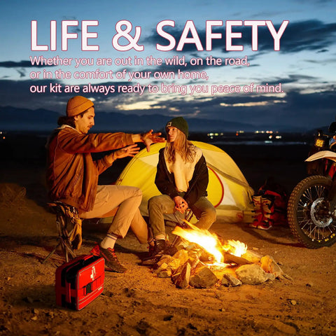 Two campers by a campfire with a Big 324 Piece First Aid Kit With Labeled Compartments for emergencies visible in the foreground.