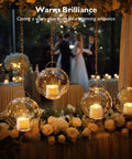 Hanging glass orbs with 48 Pack Flameless LED Tea Lights With Flickering Warm White Glow, Ivory Bases at elegant wedding venue.