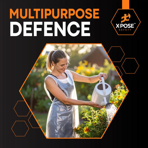 Woman wearing a White Disposable Aprons 300 Pack Individually Wrapped Waterproof Polyethylene 1 Mil Durable For Cookin, Food Prep, Cleaning And More 24 By 48 Inches Everyday Use while watering plants outdoors.